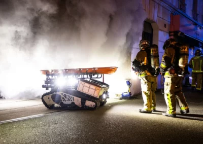 Colossus firefighting robot deployed by Paris Fire Brigade during a smoke-filled night operation.